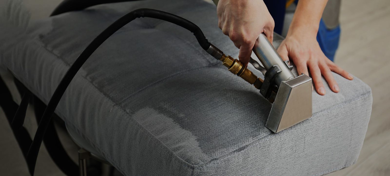 A friendly team member from Ecospin Cleaners, picking up laundry for professional cleaning and care.